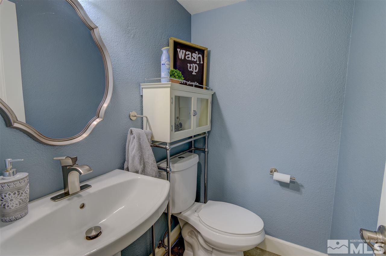 1408 East 9th Street Reno, NV 89512 - Photo 4 of 25 a bathroom with a sink mirror and toilet
