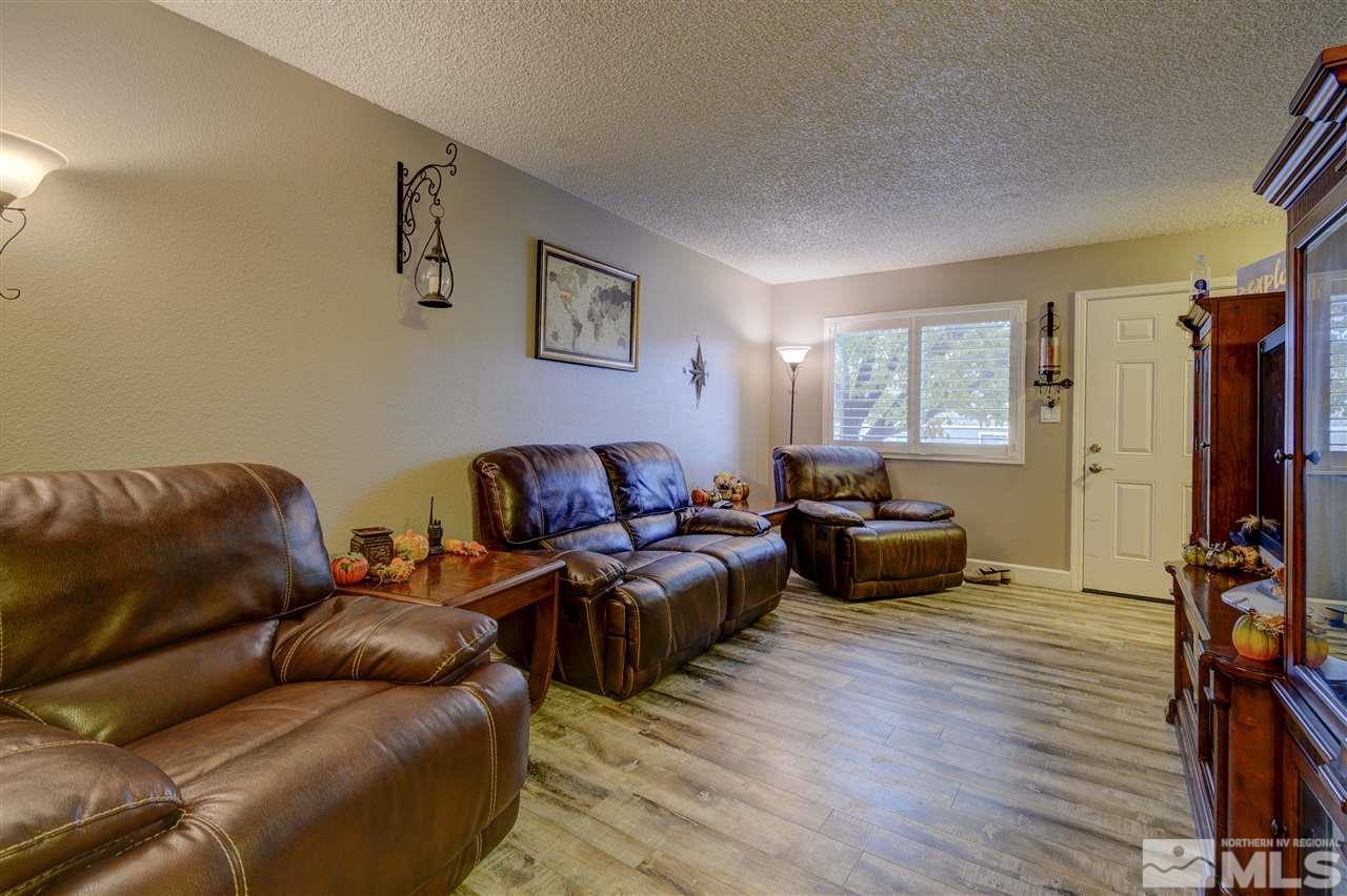 1408 East 9th Street Reno, NV 89512 - Photo 8 of 25 a living room with furniture a flat screen tv and a window