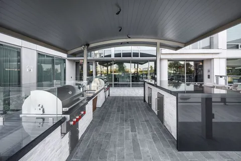 a kitchen with stainless steel appliances granite countertop a stove and wooden cabinets