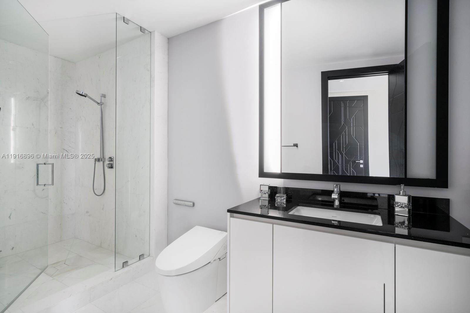 18555 Collins Avenue, Unit 3505 Sunny Isles Beach, FL 33160 - Photo 16 of 52 a bathroom with a granite countertop sink toilet and shower