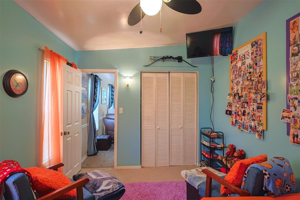 309 Tejas Trail Springtown, TX 76082 - Photo 24 of 40 a bedroom with furniture and a chandelier