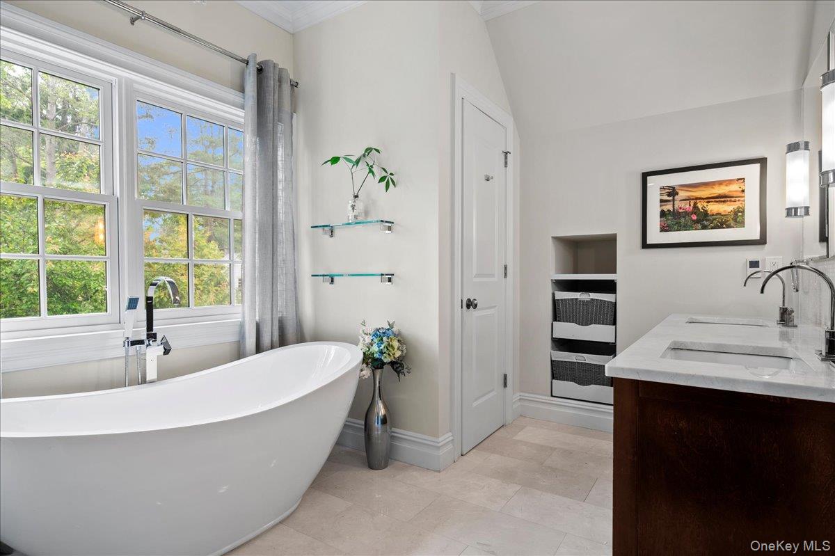 7 Harcourt Road Scarsdale, NY 10583 - Photo 19 of 34 a bathroom with a tub a sink and a window