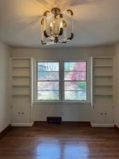 an empty room with wooden floor