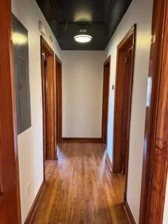a view of hallway with wooden floor