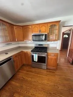 a kitchen with stainless steel appliances granite countertop a stove a sink and a microwave
