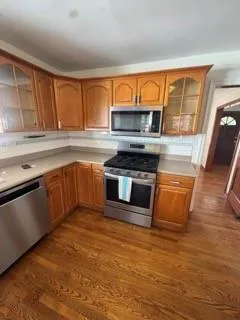 a kitchen with stainless steel appliances granite countertop a stove a sink and a microwave