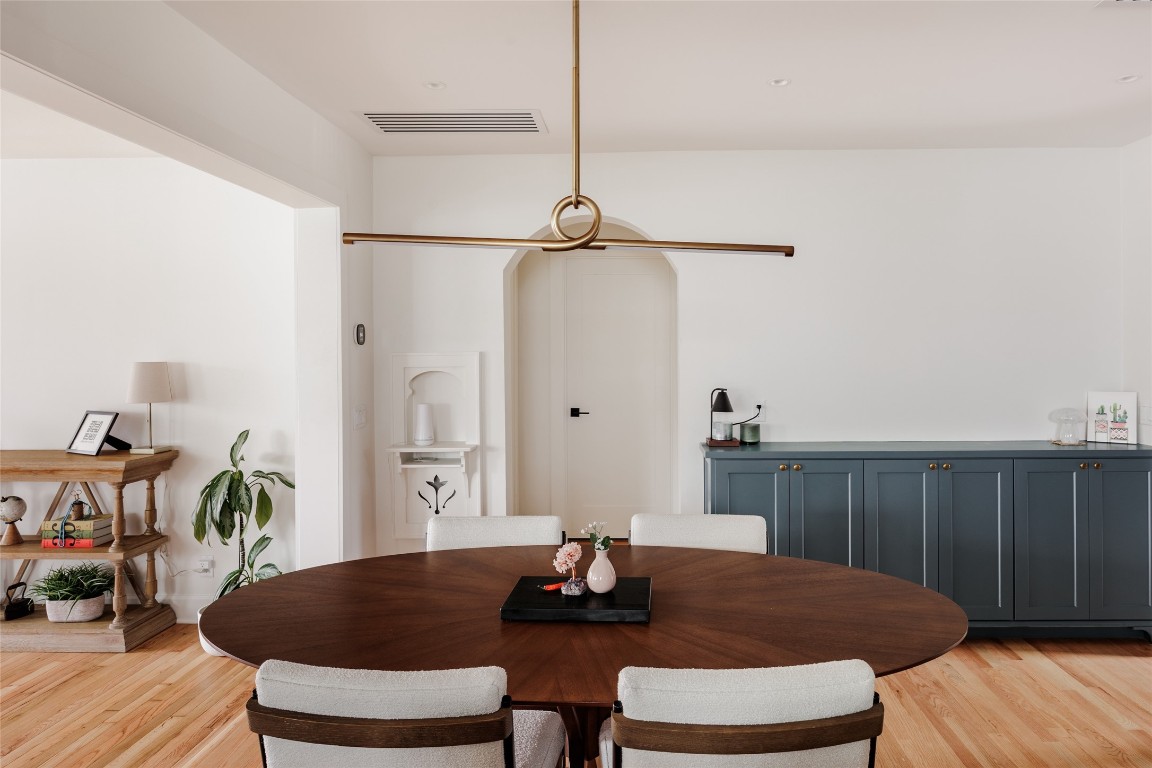 2613 East 2nd Street Austin, TX 78702 - Photo 13 of 30 a dining room with furniture and wooden floor