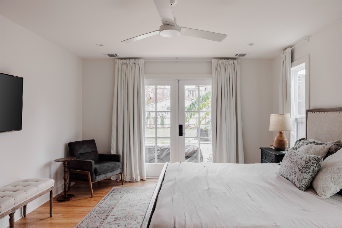 2613 East 2nd Street Austin, TX 78702 - Photo 18 of 30 a bedroom with a bed and a chandelier