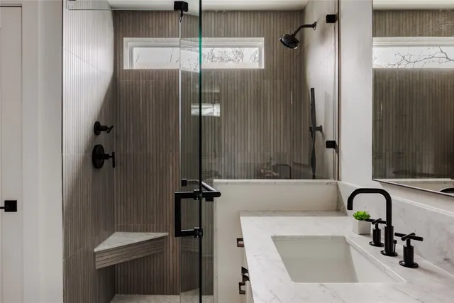 a bathroom with a bathtub and shower