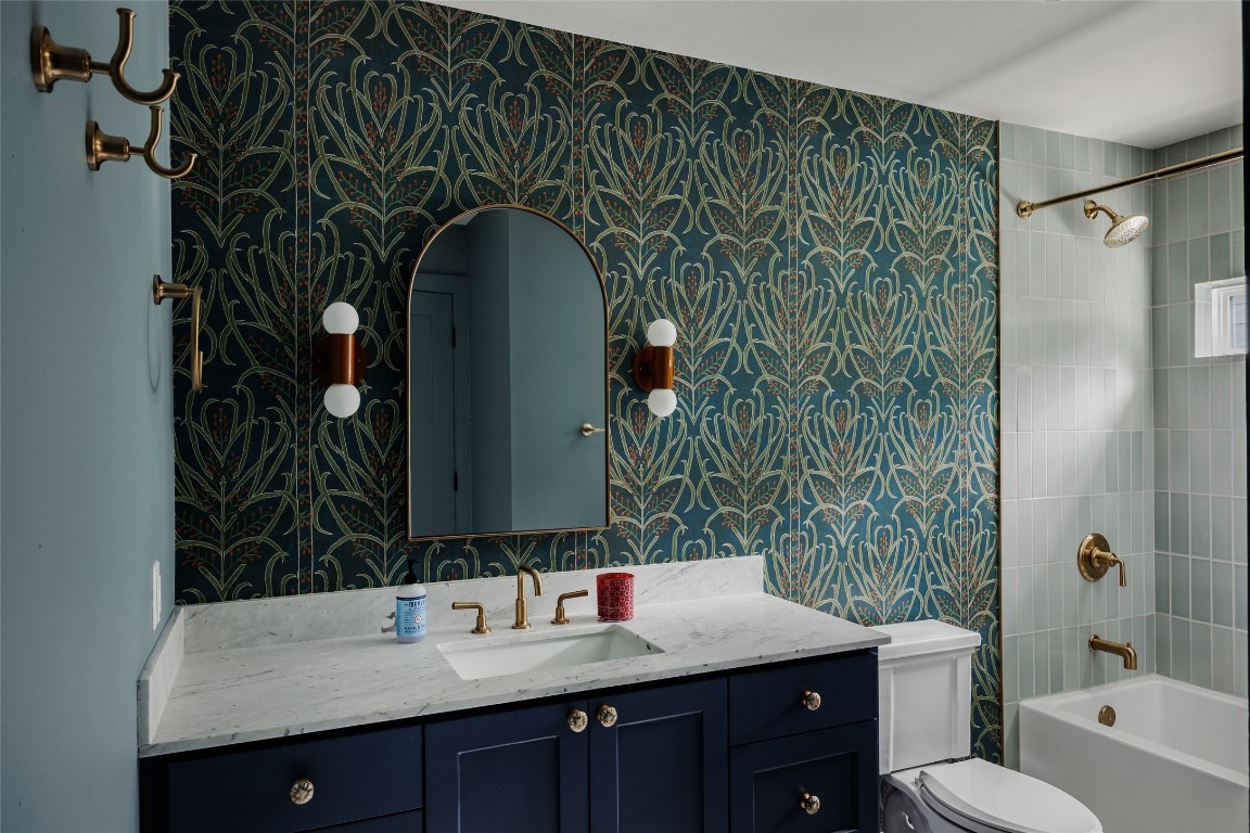 2613 East 2nd Street Austin, TX 78702 - Photo 26 of 30 a bathroom with a granite countertop sink a toilet and shower