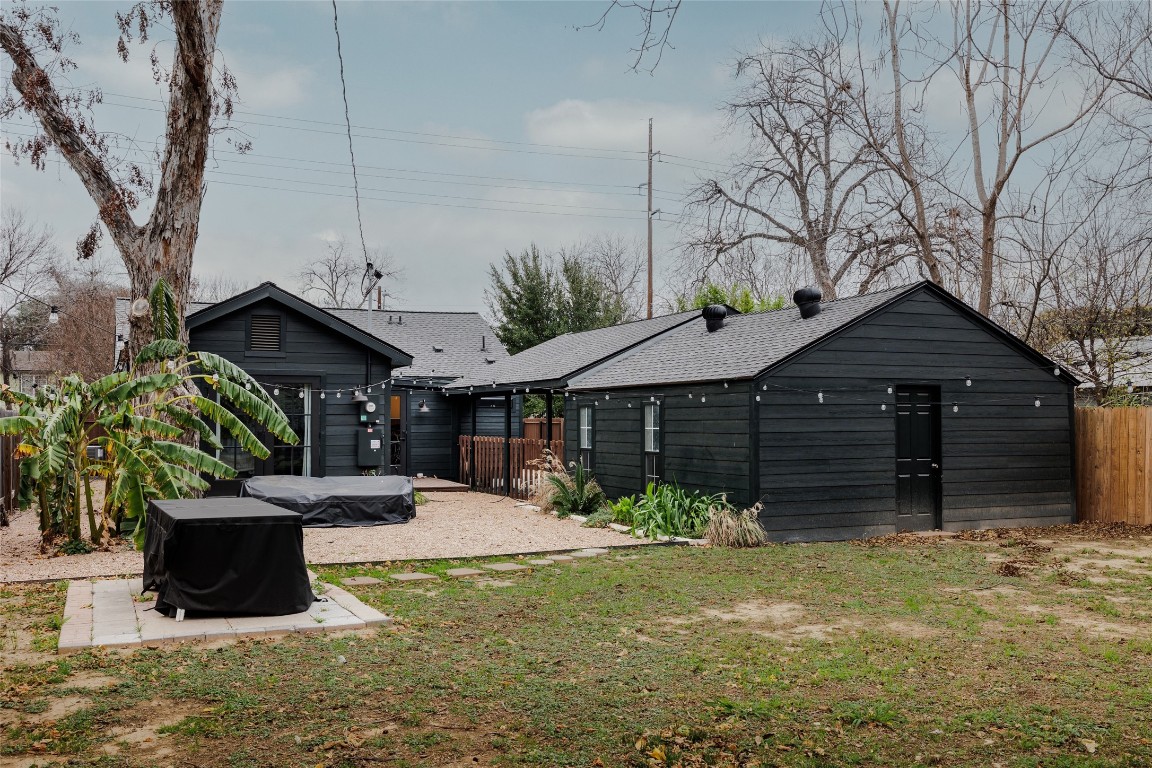 2613 East 2nd Street Austin, TX 78702 - Photo 30 of 30 a front view of a house with a yard and potted plants