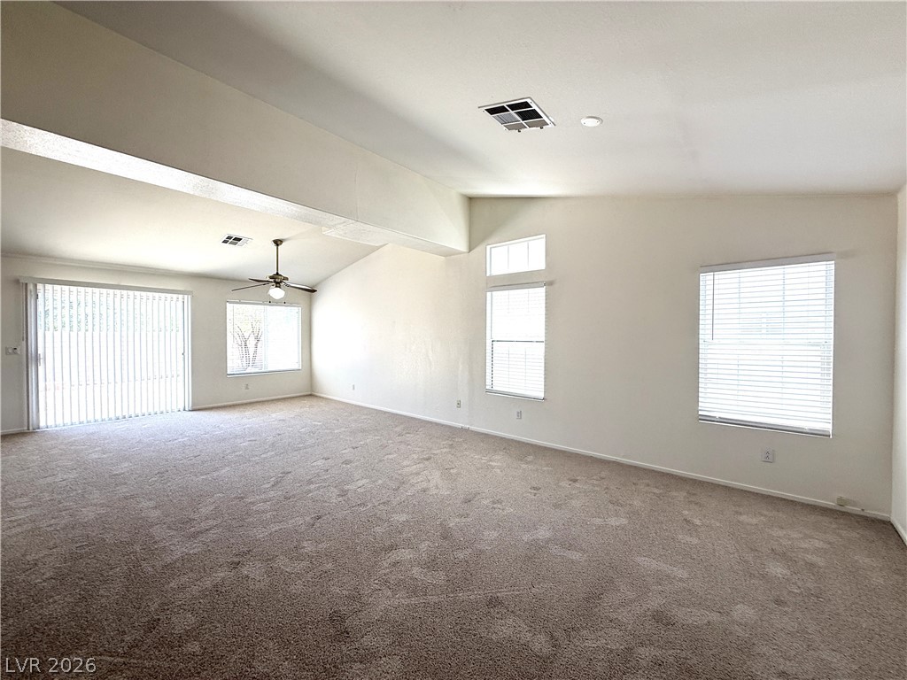 8870 Haviland Road Las Vegas, NV 89123 - Photo 9 of 22 A spacious living area with vaulted ceilings and abundant natural illumination awaits.