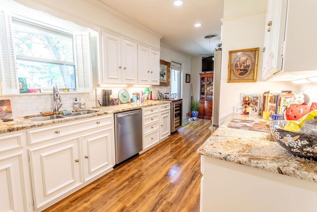 149 Russ Street Albany, TX 76430 - Photo 12 of 25 a large kitchen with stainless steel appliances granite countertop a stove sink and cabinets