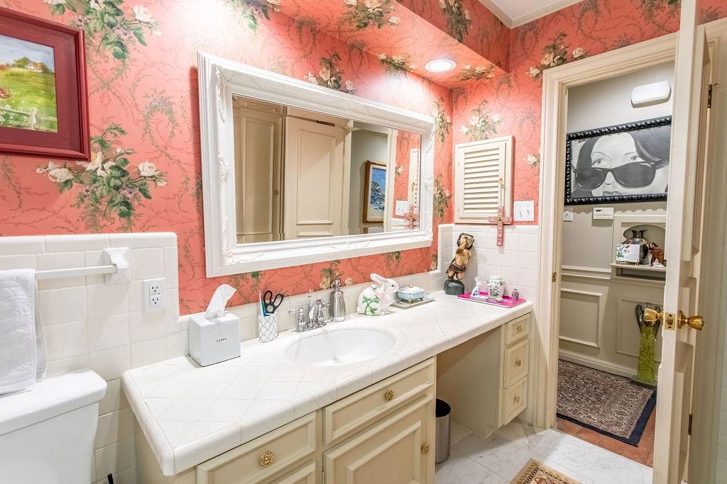 149 Russ Street Albany, TX 76430 - Photo 18 of 25 a bathroom with a sink and a mirror