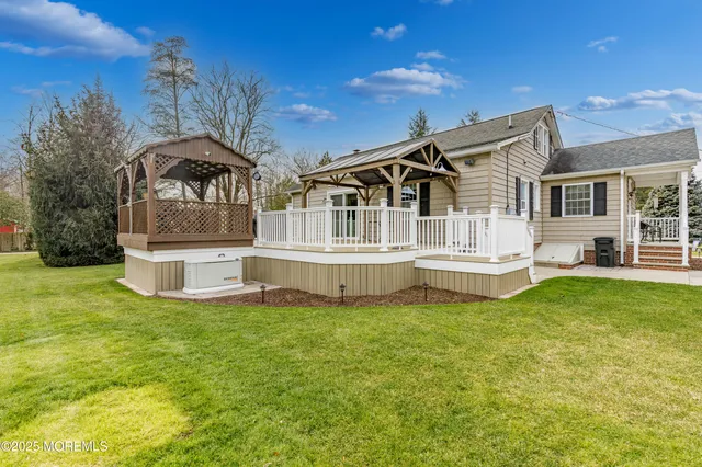 a white house that has a big yard and more windows