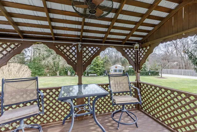 a view of a patio with table and chairs and wooden floor