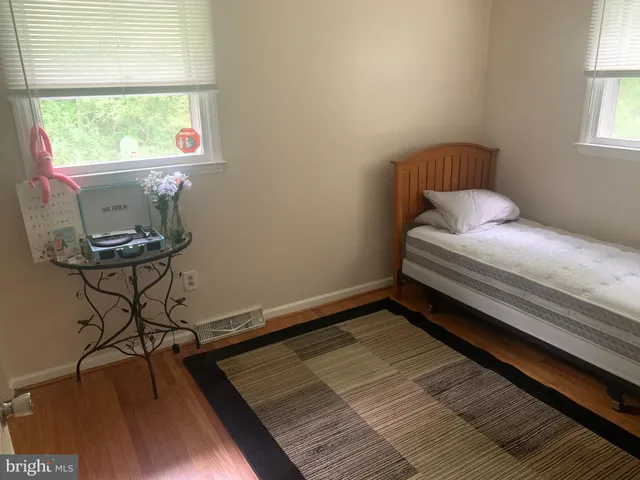 a room with water heater and wooden cabinets