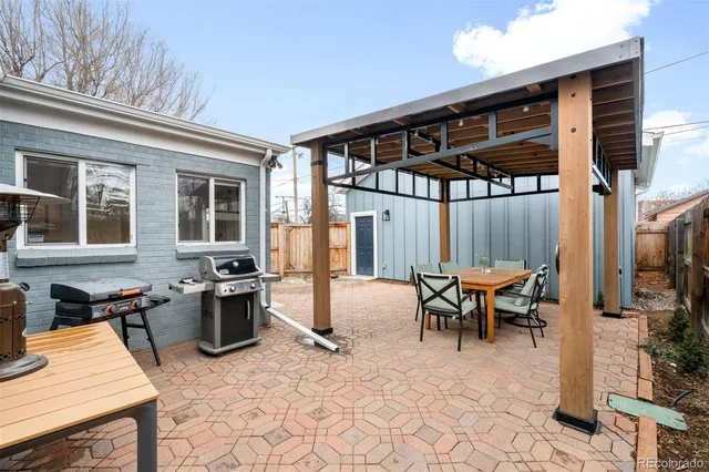 a view of a backyard with wooden fence