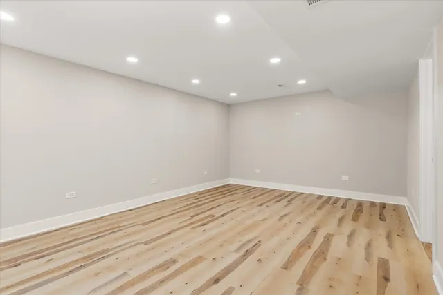 a view of room with wooden floor and fan