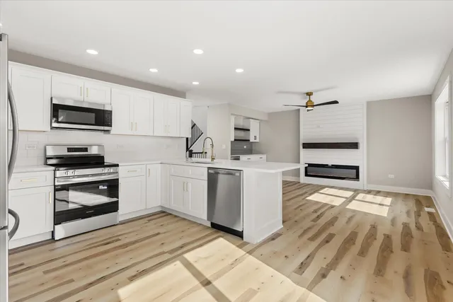 a kitchen with a sink stainless steel appliances and cabinets