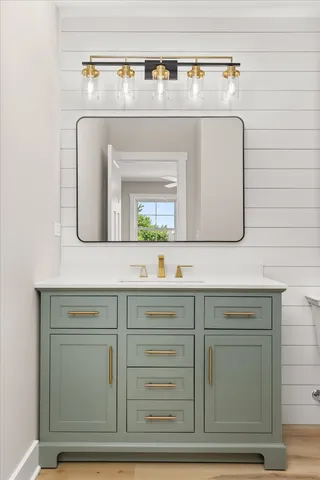 a bathroom with a sink mirror and vanity