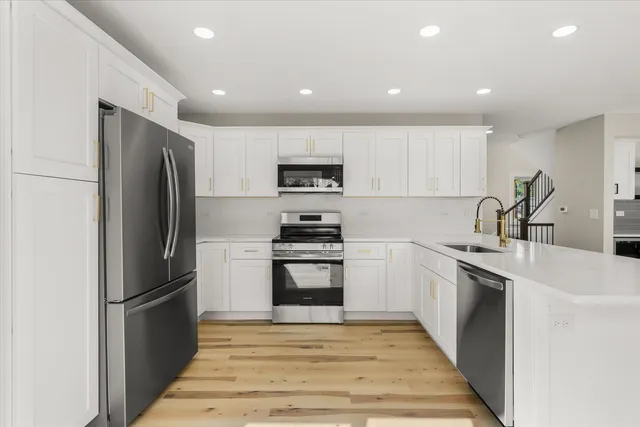 a kitchen with a sink stainless steel appliances and cabinets