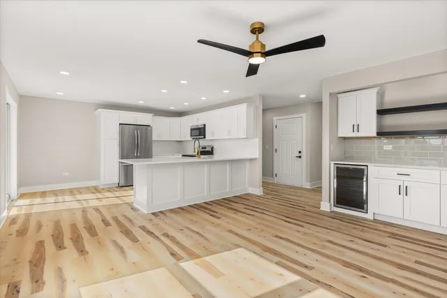 a view of kitchen with cabinets microwave and stove
