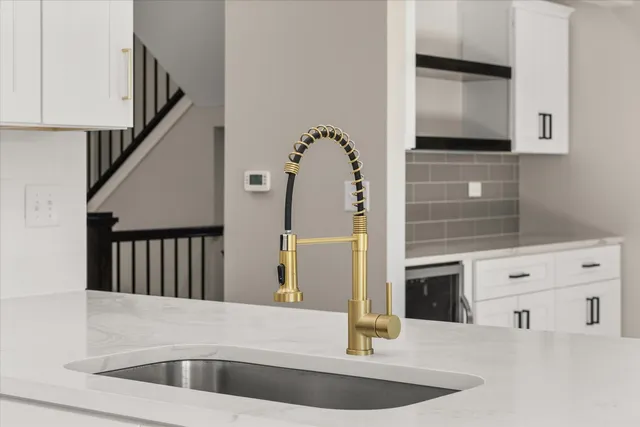 a view of kitchen with sink and mirror