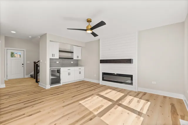 a view of a kitchen with wooden floor a sink and windows