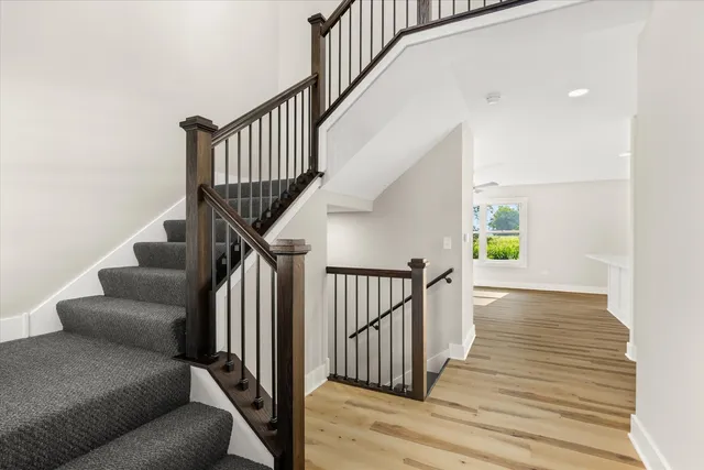 a view of entryway and hall with wooden floor