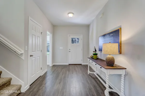 a bedroom with furniture and wooden floor