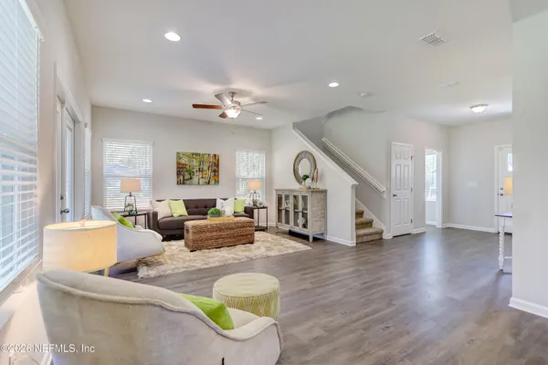 a living room with furniture and a ceiling fan
