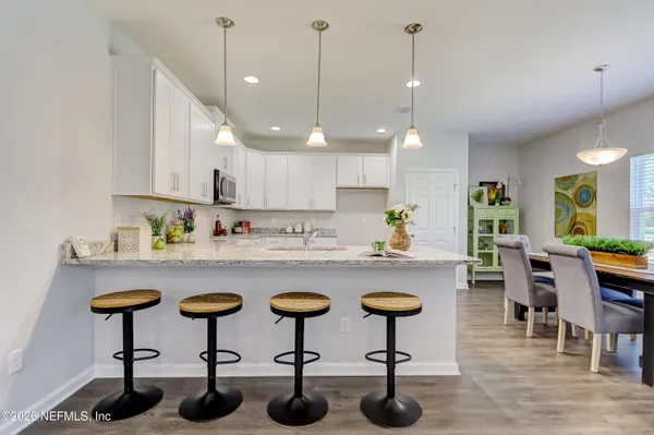 a kitchen with sink and chairs