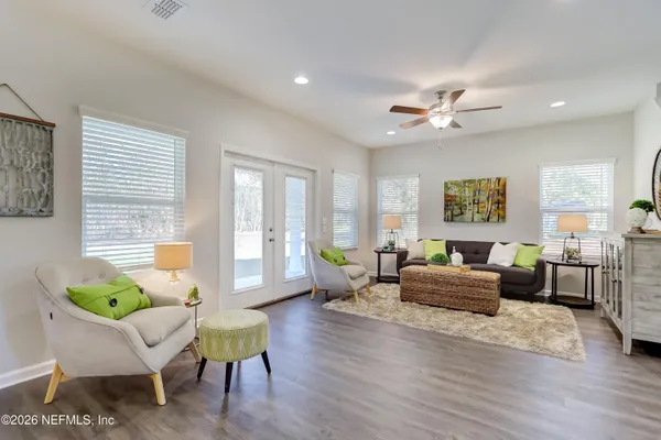 a living room with furniture dining area and a window