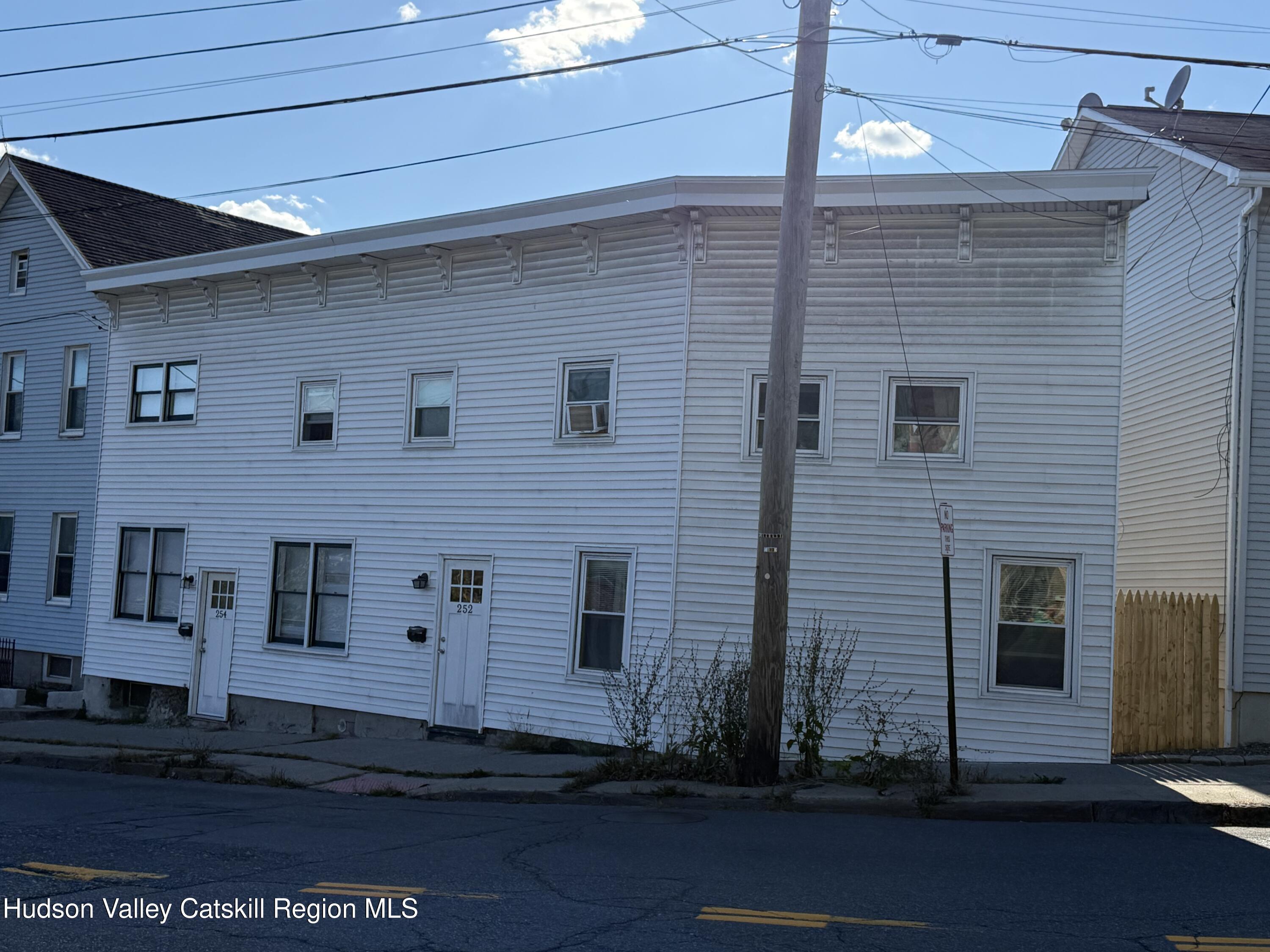 252-254 Partition Street Saugerties, NY 12477 - Photo 2 of 11 a view of a brick house with many windows