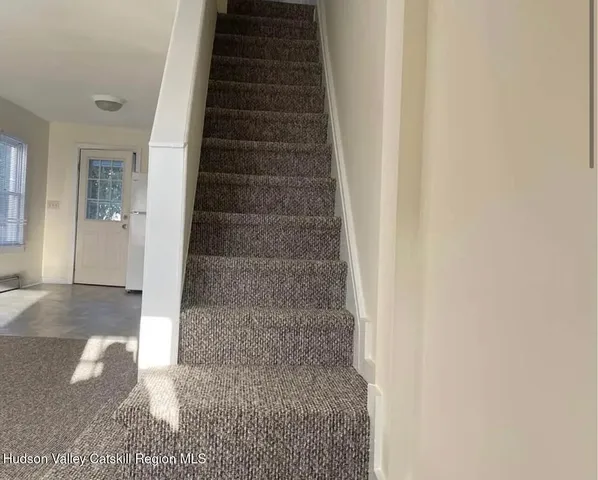 a view of staircase with white walls
