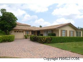 19 Ridge Boulevard Ocean Ridge, FL 33435 - Photo 2 of 4 a front view of a house with a yard and garage