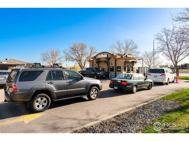 a view of cars parked in front of a building