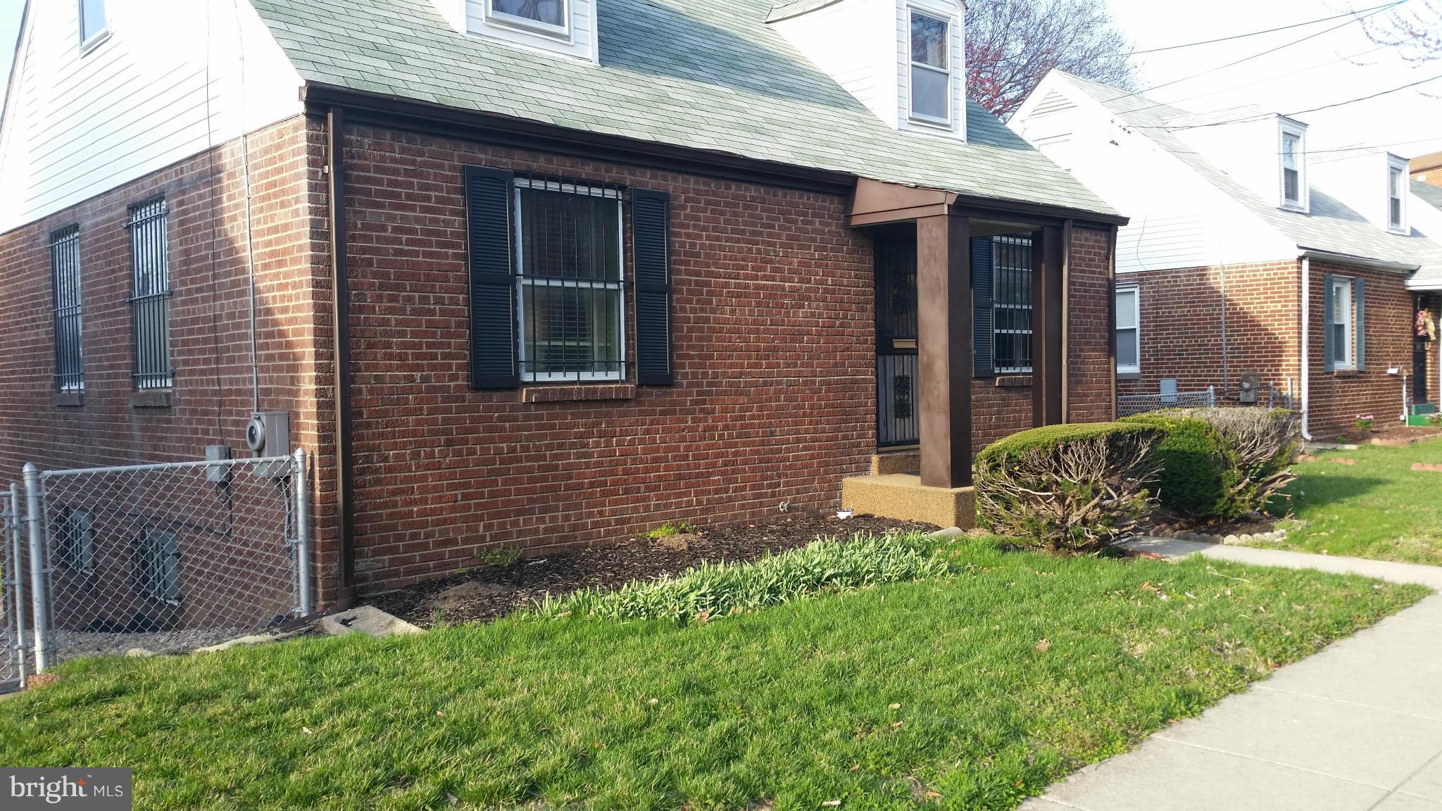 4636 Easy Place Southeast Washington, DC 20019 - Photo 3 of 29 a view of a brick house with a yard potted plants and a table