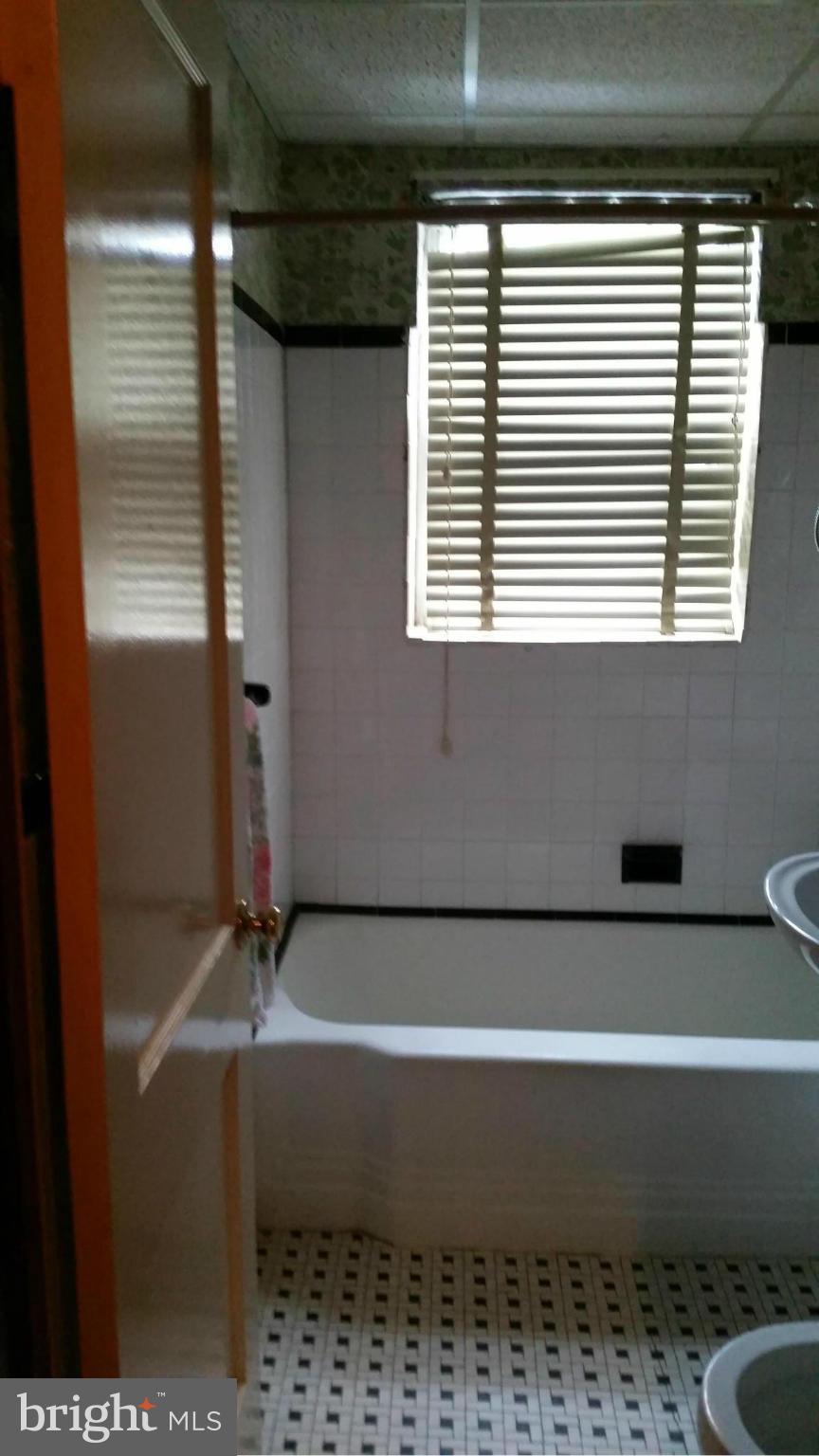 4636 Easy Place Southeast Washington, DC 20019 - Photo 21 of 29 a bathroom with a bathtub and next to a window