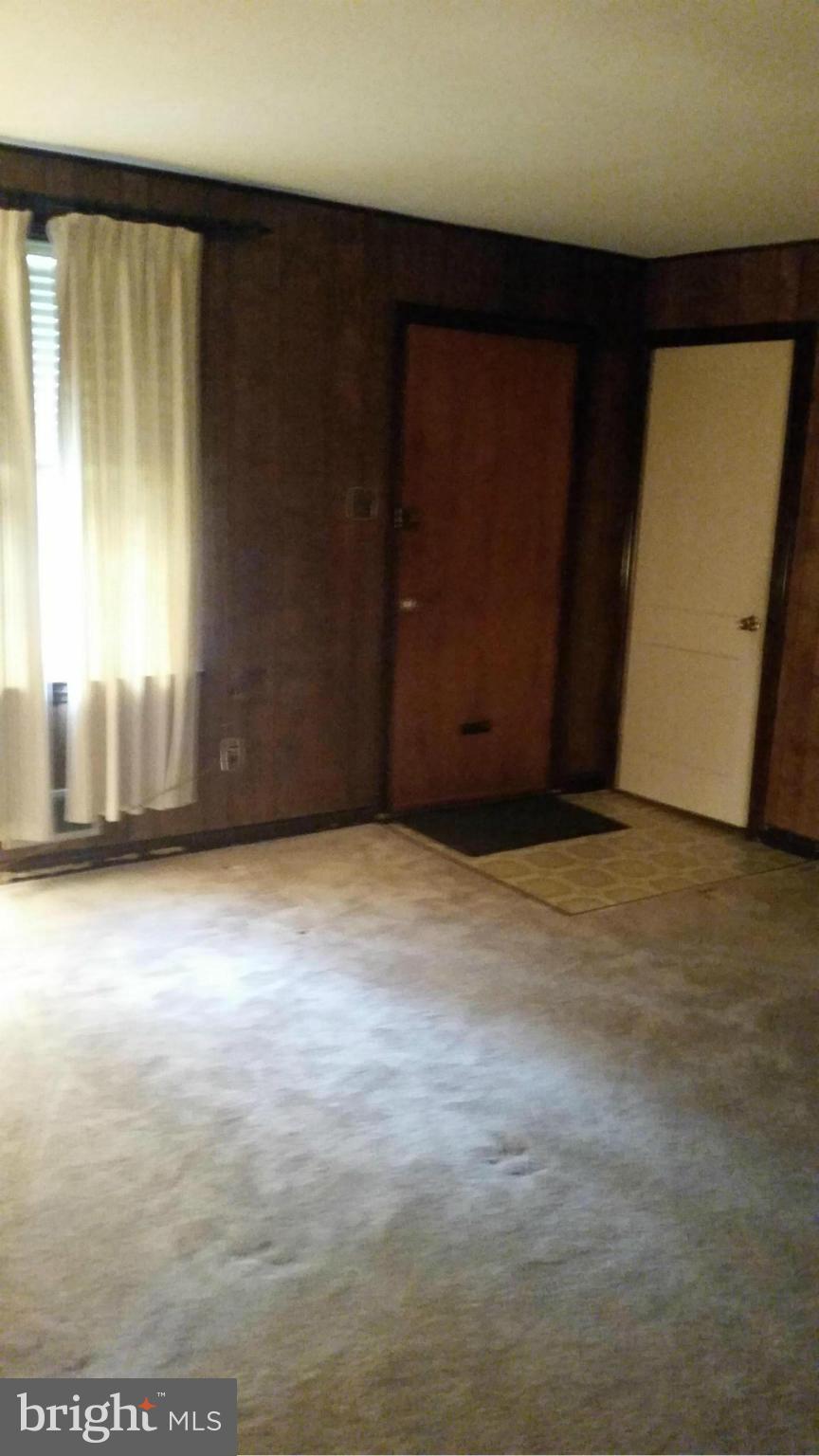 4636 Easy Place Southeast Washington, DC 20019 - Photo 8 of 29 an empty room with wooden floor and windows with curtains