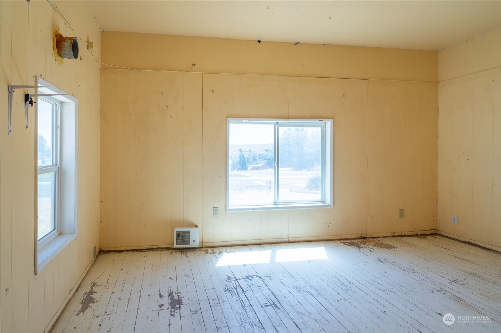 506 North I Street Lind, WA 99341 - Photo 25 of 40 an empty room with wooden floor and windows
