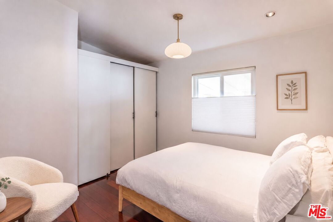 29500 Heathercliff Road, Unit 275 Malibu, CA 90265 - Photo 34 of 35 a bedroom with a bed and a chair