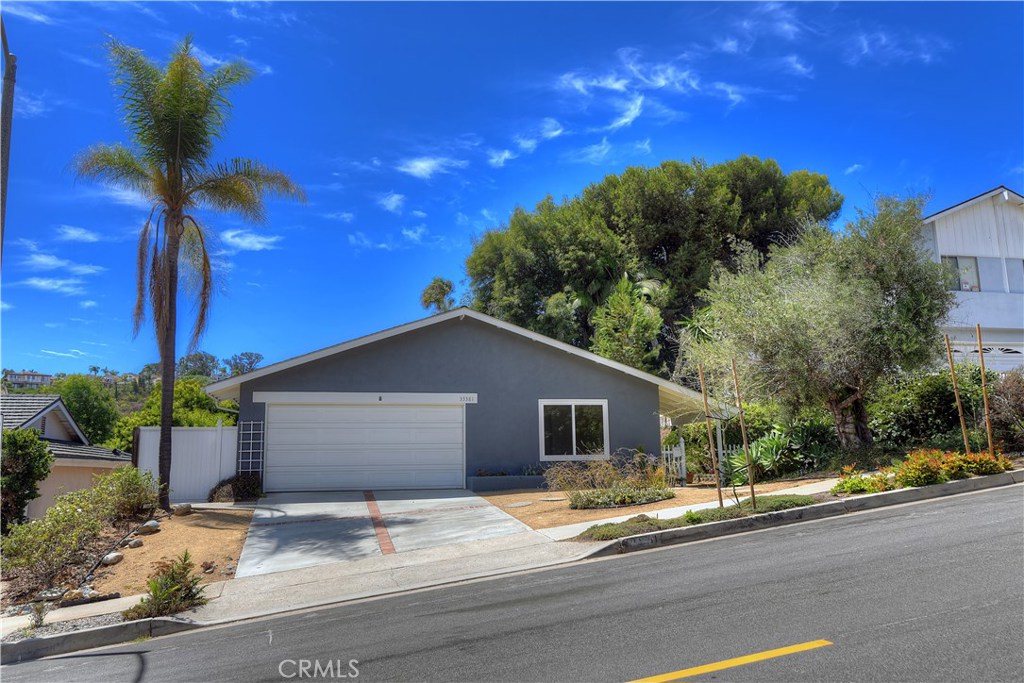 a yellow house with trees in front of it