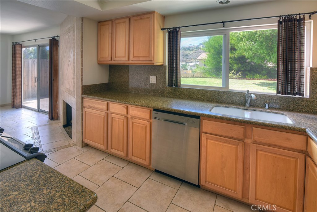 33381 Ocean Hill Drive Dana Point, CA 92629 - Photo 15 of 45 a kitchen with granite countertop a sink window and cabinets