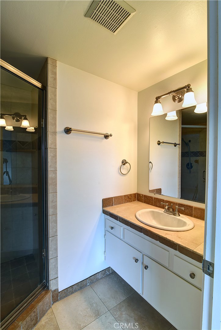 33381 Ocean Hill Drive Dana Point, CA 92629 - Photo 21 of 45 a bathroom with a granite countertop sink and a mirror