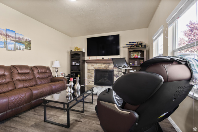 2005 Redtail Way Layton, UT 84040 - Photo 16 of 37 Living area featuring wood-finish flooring, a stone-faced fireplace with a mantel, and recessed lighting