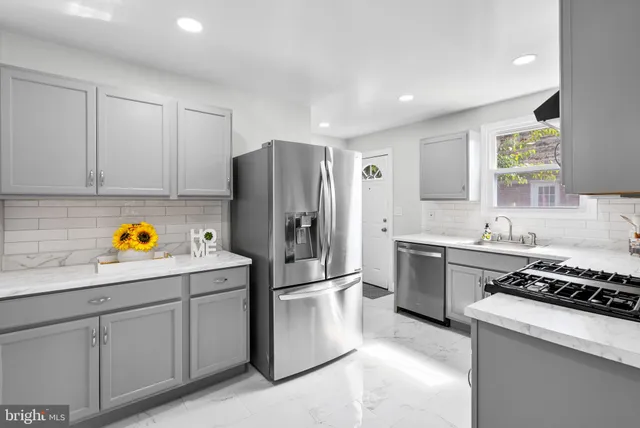 a kitchen with a refrigerator and a sink