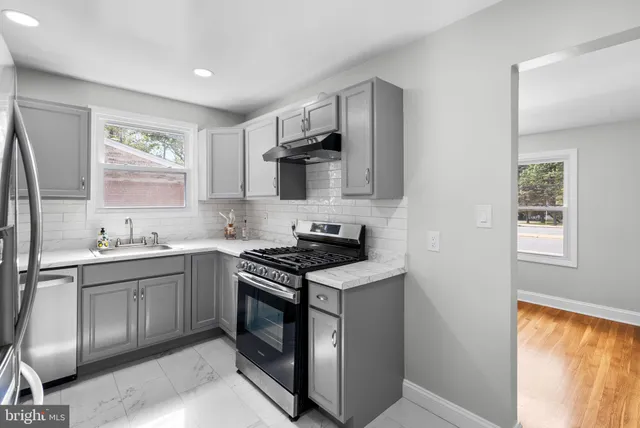 a kitchen with stainless steel appliances granite countertop a stove and a sink