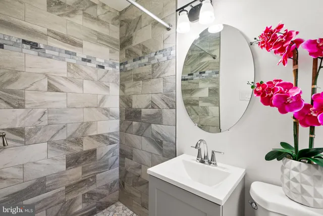a bathroom with a sink mirror and vanity